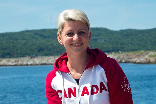 smiling woman explores Chedabucto Bay Estates and environment, Nova Scotia