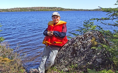 Boy on Lake Shore at Seven Peninsula Estates, Private Acres and Islands, Cape Breton 