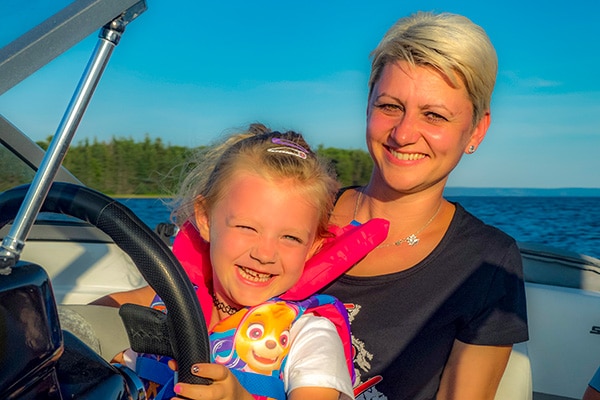 Mom and daughter having fun on a boat trip on the Bras dor Lake